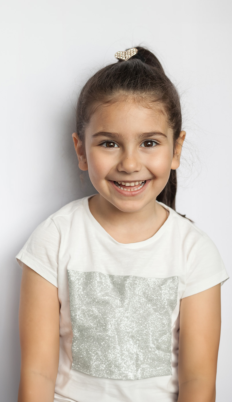 The image shows a modern dental or medical office interior with a dental chair, equipment, and a clean, professional environment.