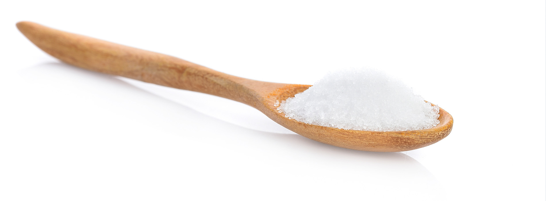 The image shows two wooden spoons with salt crystals on them against a white background.